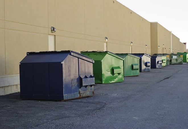 a stack of yellow construction dumpsters on a job site in Amesbury